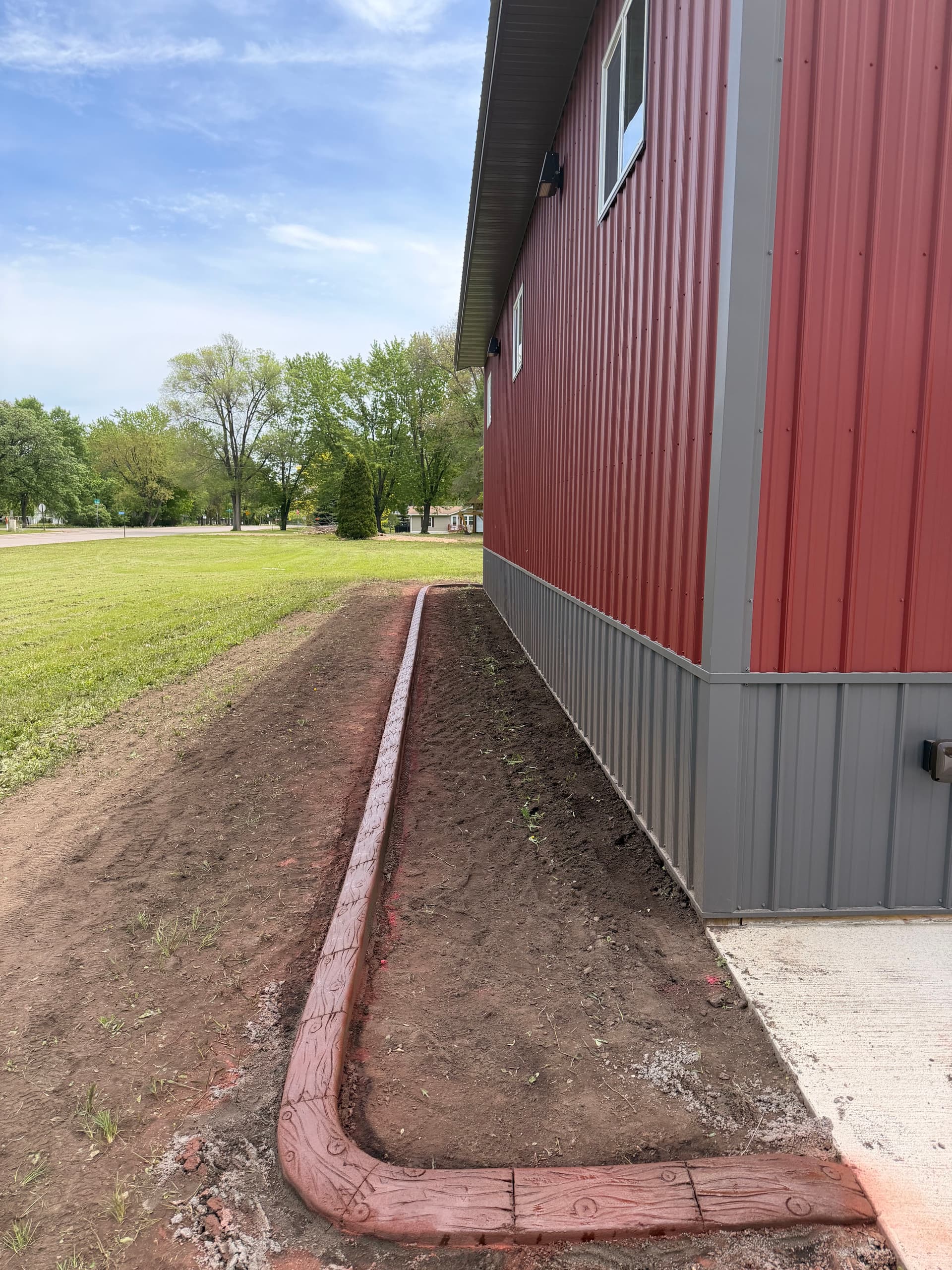 Stamped Concrete Curbing Wraps a Building in Fairhaven MN image