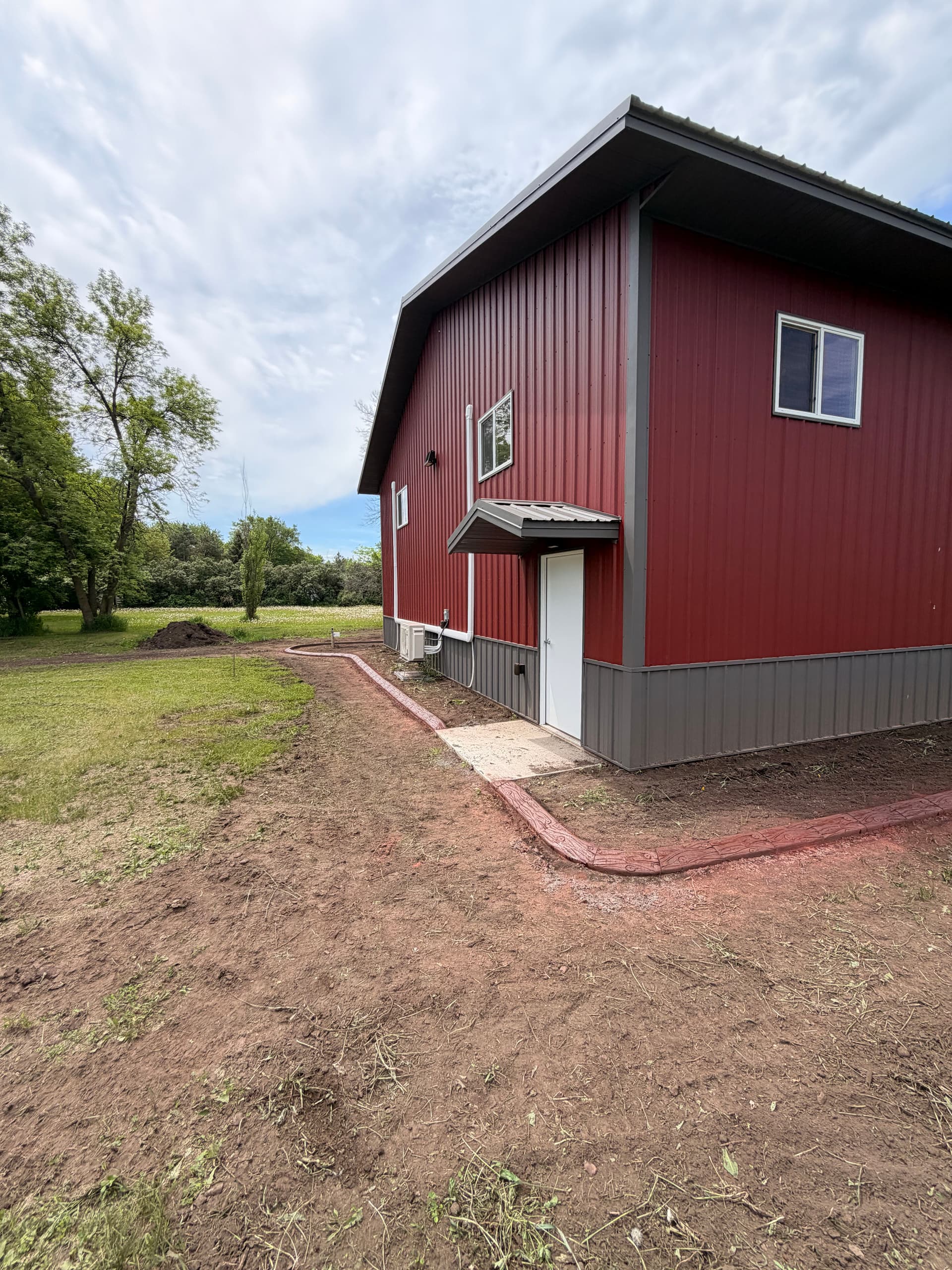 Gallery photos for Stamped Concrete Curbing Wraps a Building in Fairhaven MN: Image #1