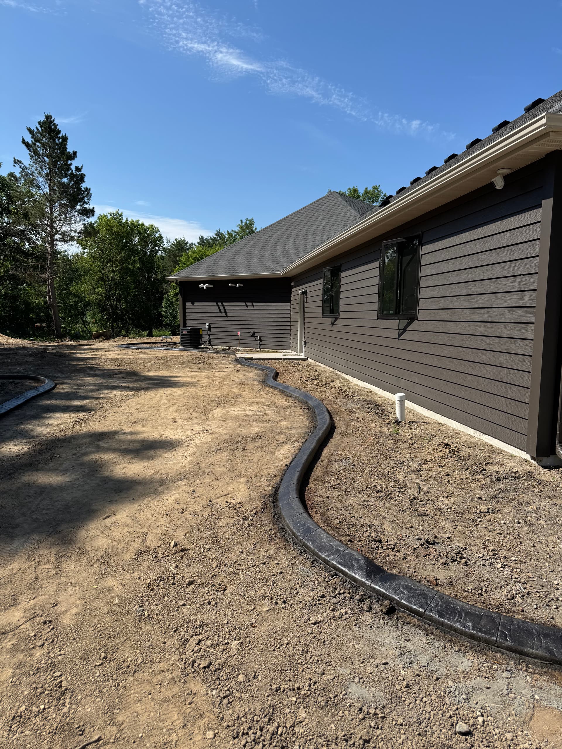 Concrete Curbing With a Deep Charcoal Slate Stamp in Rogers image