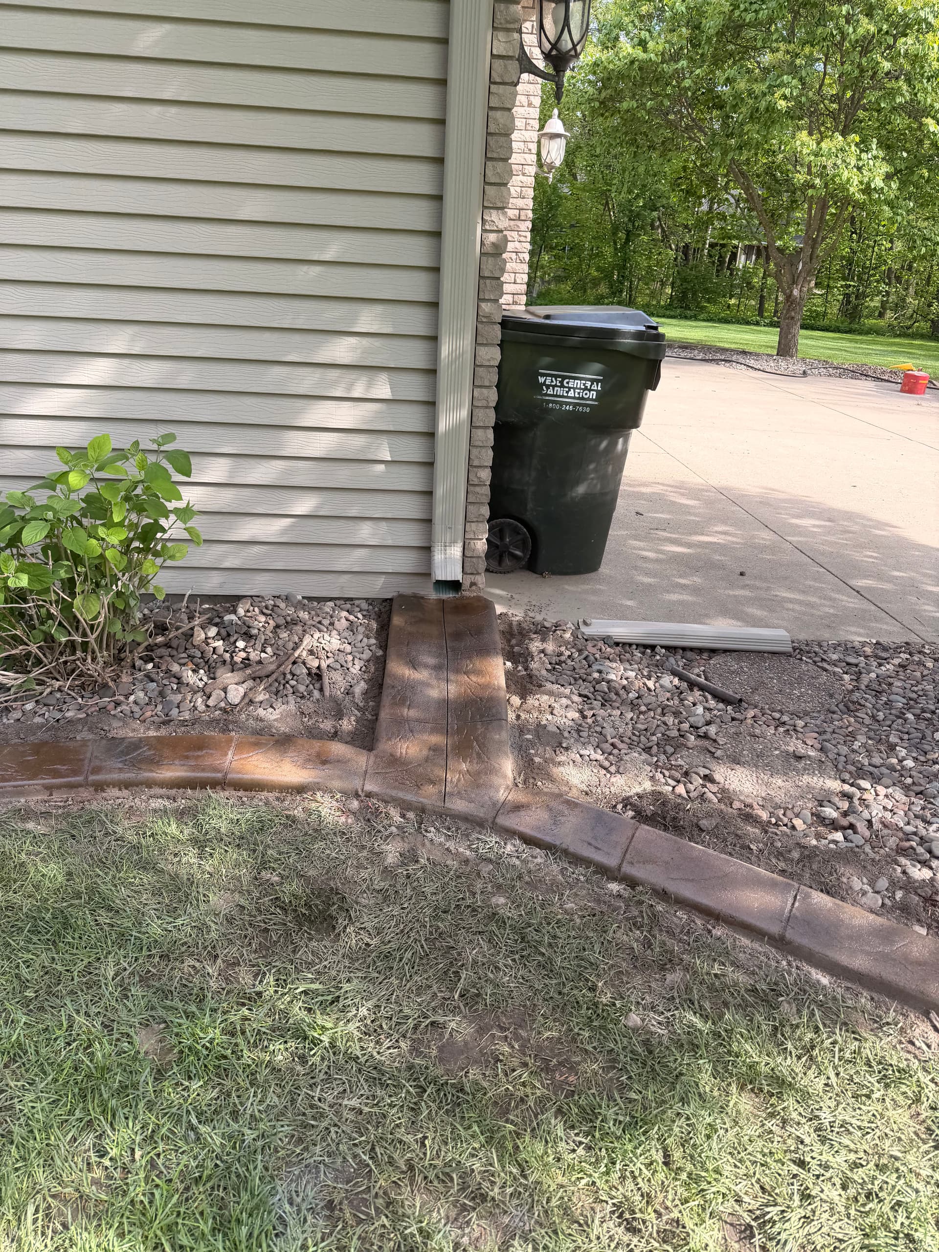 Gallery photos for Stamped Concrete Curbing with Custom Downspout Pads Upgrades Curb Appeal: Image #2